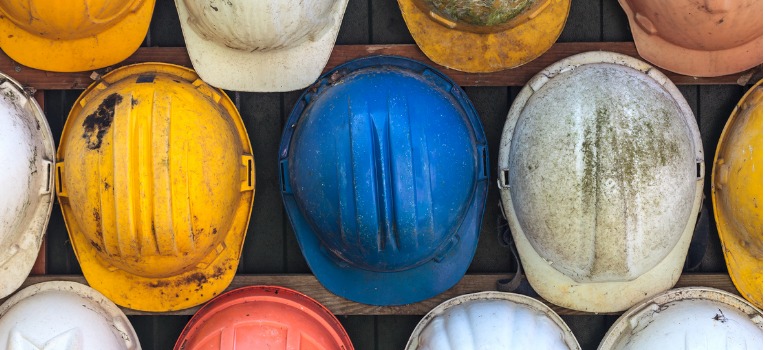 Construction hats hanging on wall